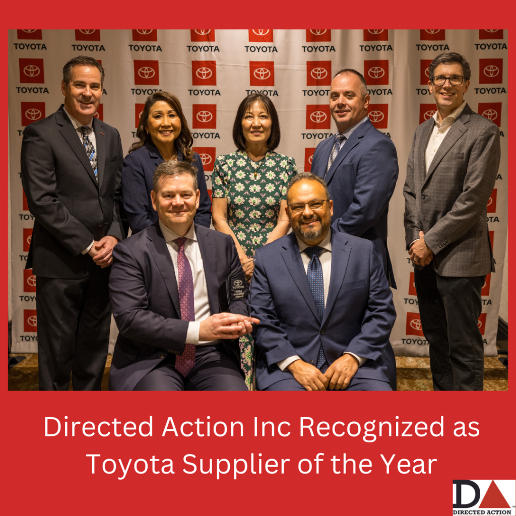 Directed Action Inc Recognized as Toyota Supplier of the Year. Seven people including Kevin Keane, COO of Directed Action pose in front of a Toyota step and repeat to honor Directed Action on their win for supplier of the year for Toyota.